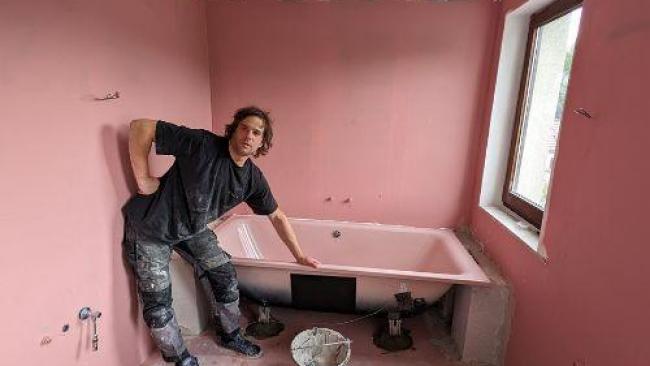 La pose d'une baignoire dans une salle de bain en rénovation
